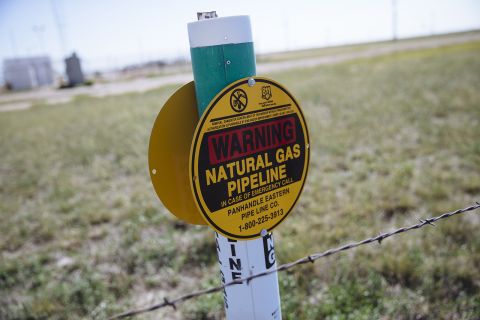 A warning sign for an underground natural gas pipeline stands near Sunray, Texas, U.S., on Saturday, Sept. 26, 2020. 