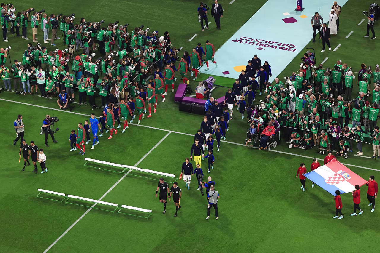 Players and match officials line up prior to the match between Croatia and Morocco on December 17. 