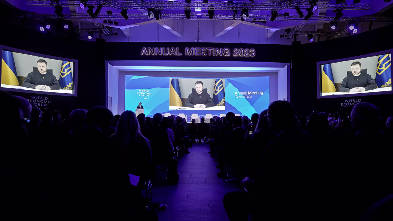 Ukrainian President Volodymyr Zelensky talks from a video screen to participants at the World Economic Forum in Davos, Switzerland, on Wednesday. 