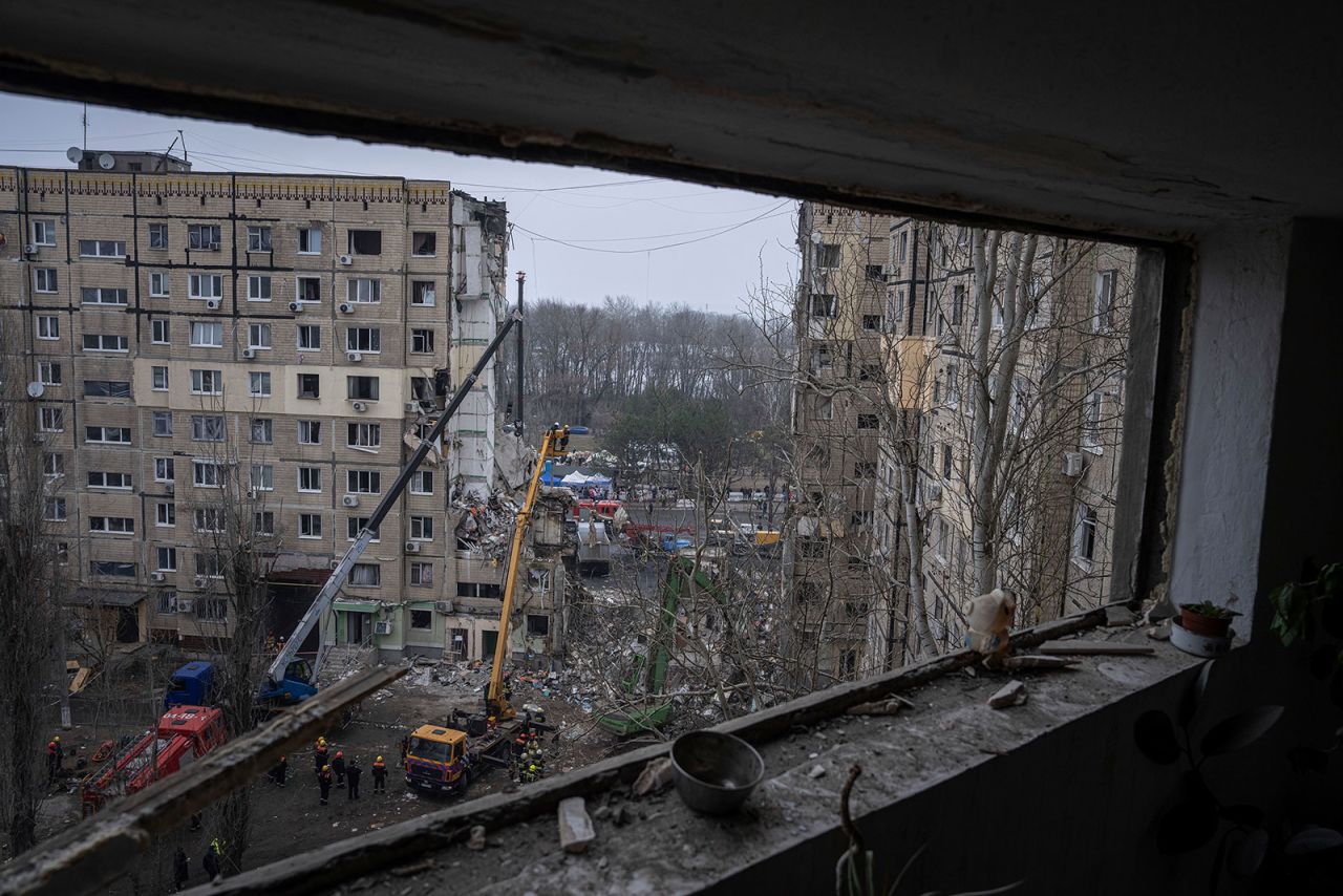 Rescue workers clear rubble from the site of Saturday's Russian missile strike that destroyed an apartment building in Dnipro, Ukraine, on Monday.
