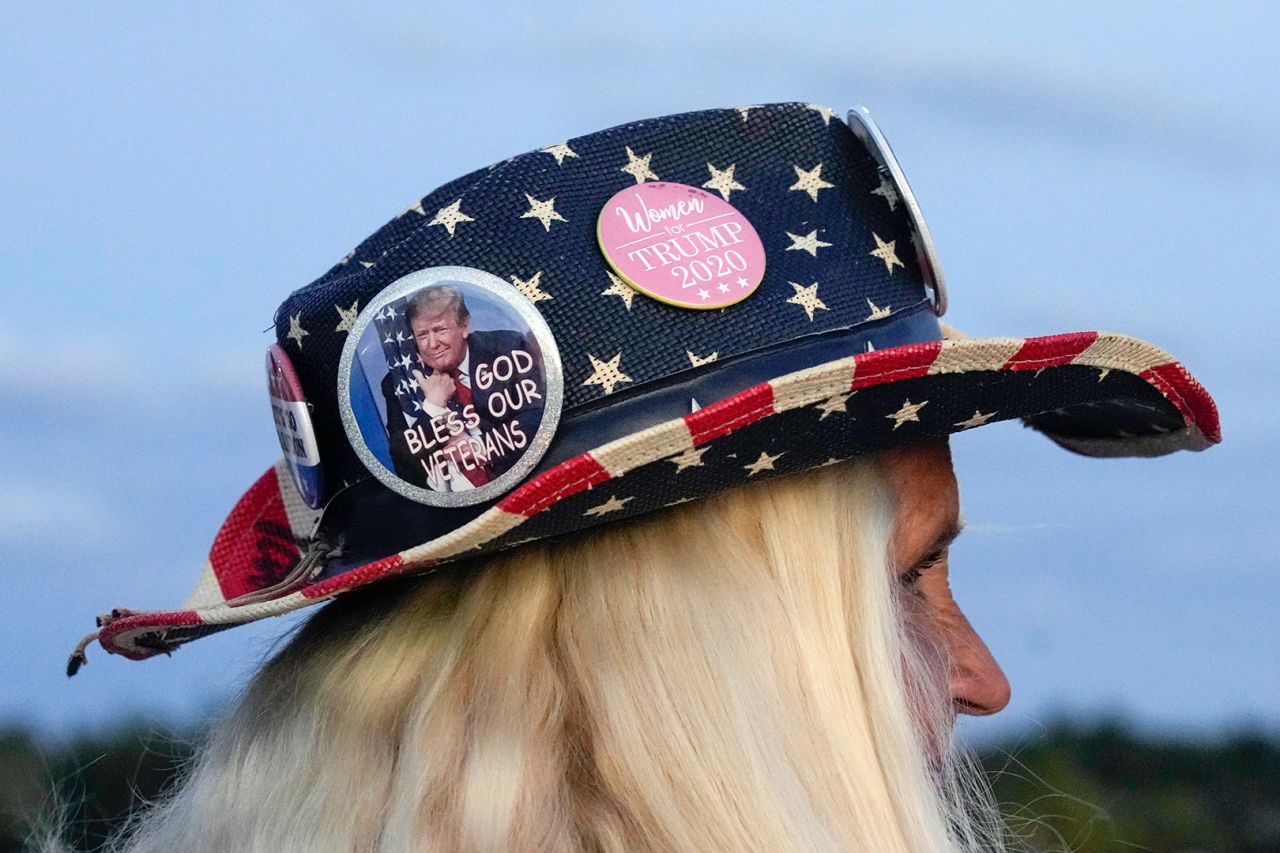 Kathy Clark of Lantana, Florida, wears an American flag hat with Trump pins as she shows her support for former President Donald Trump.