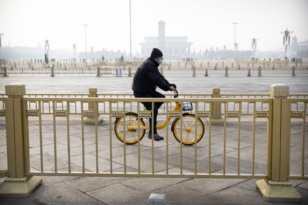 A cyclist rides past Beijing's Tiananmen Square, normally crowded with tourists during the Lunar New Year holiday, on January 27.