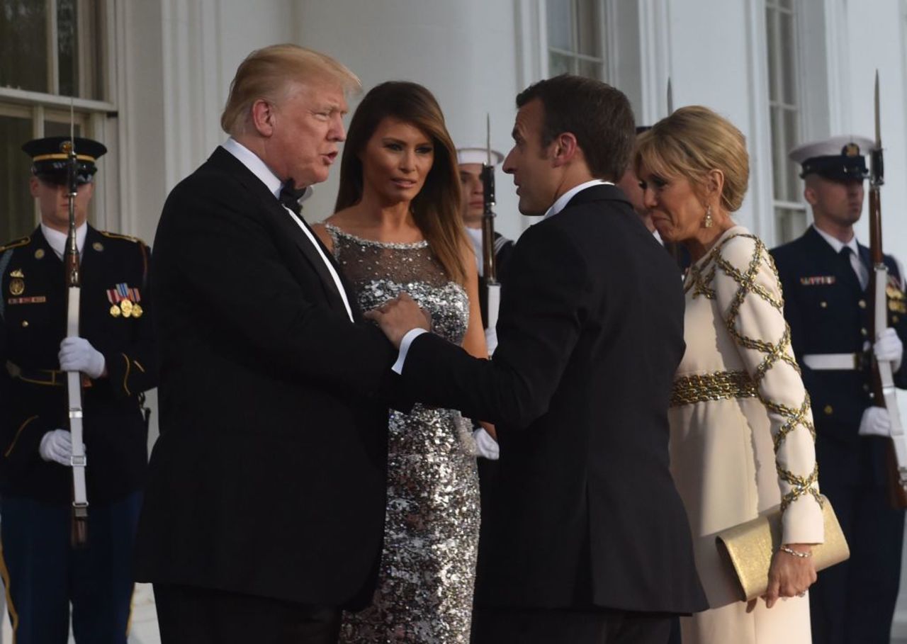 US President Donald Trump and First Lady Melania Trump welcome French President Emmanuel Macron and his wife, Brigitte Macron, as they arrive for a State Dinner at the North Portico of the White House in Washington, DC, April 24, 2018.