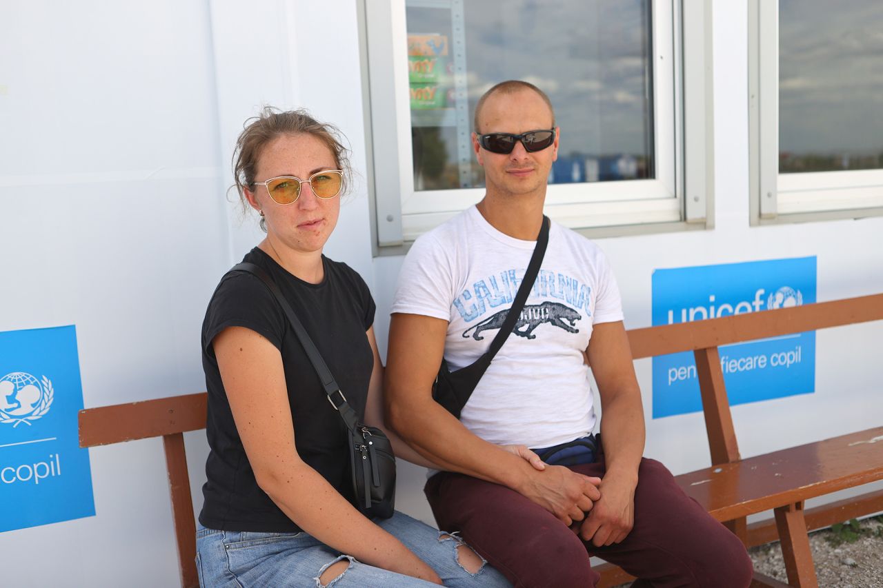 Viktor and Svetlana Maximchuk wait for transportation at the Moldovan side of the Moldova-Ukraine border in Palanca.