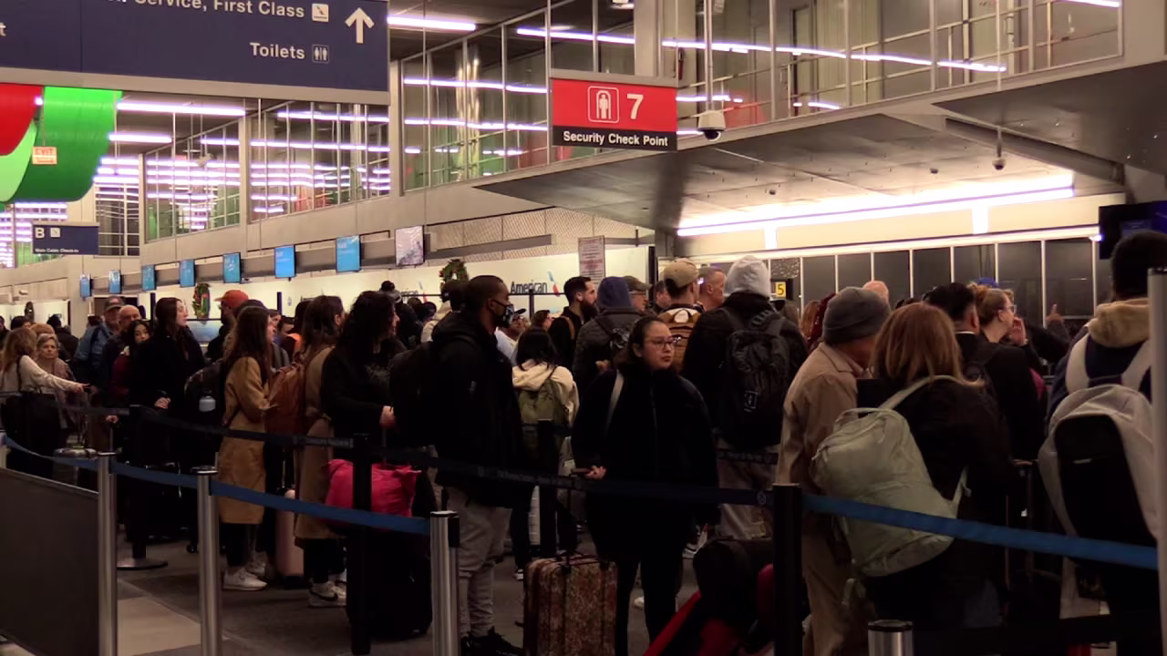 Passengers stand in line at O’Hare International Airport in Chicago on Friday.