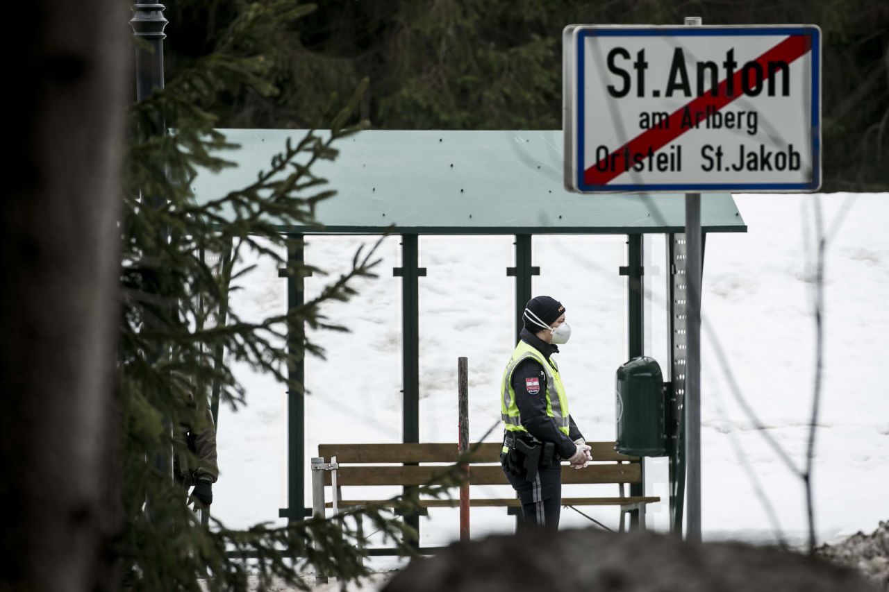 A police officer is seen at a roadblock near St Anton following the imposition of a quarantine due to the coronavirus on March 14, near Landeck, Austria.