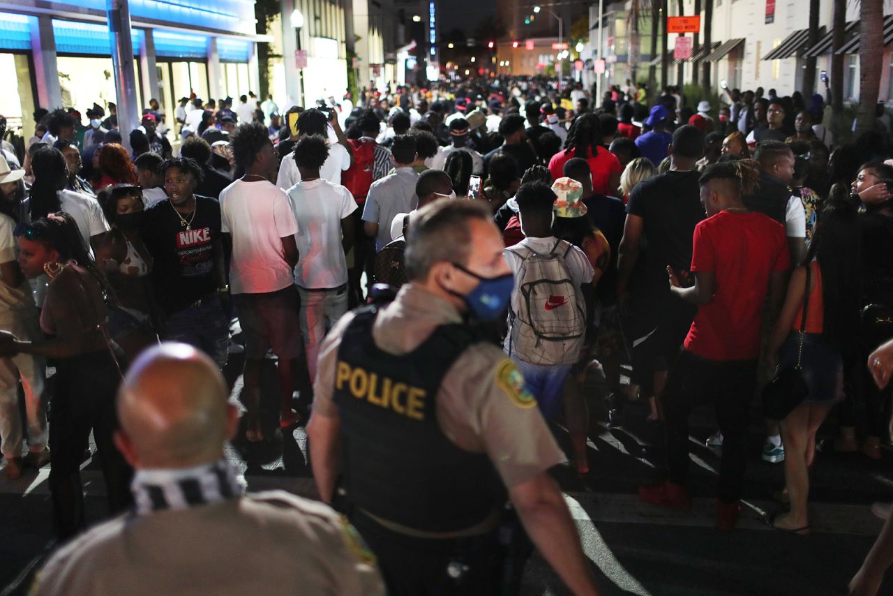 People leave the area as an 8pm curfew goes into effect in Miami Beach, Florida, on March 21.