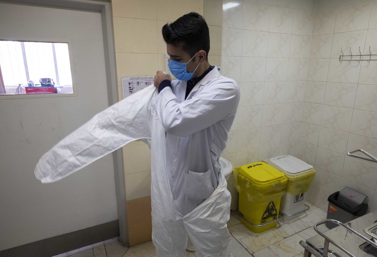 A hospital staff member prepares to enter an isolation room of a suspected coronavirus patient at a hospital in Tehran, on February 9.