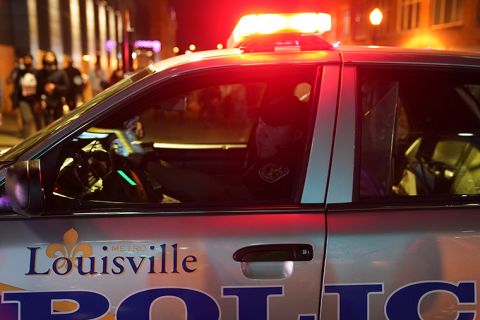 A police officer observes protesters, Thursday, September 24, in Louisville, Kentucky.
