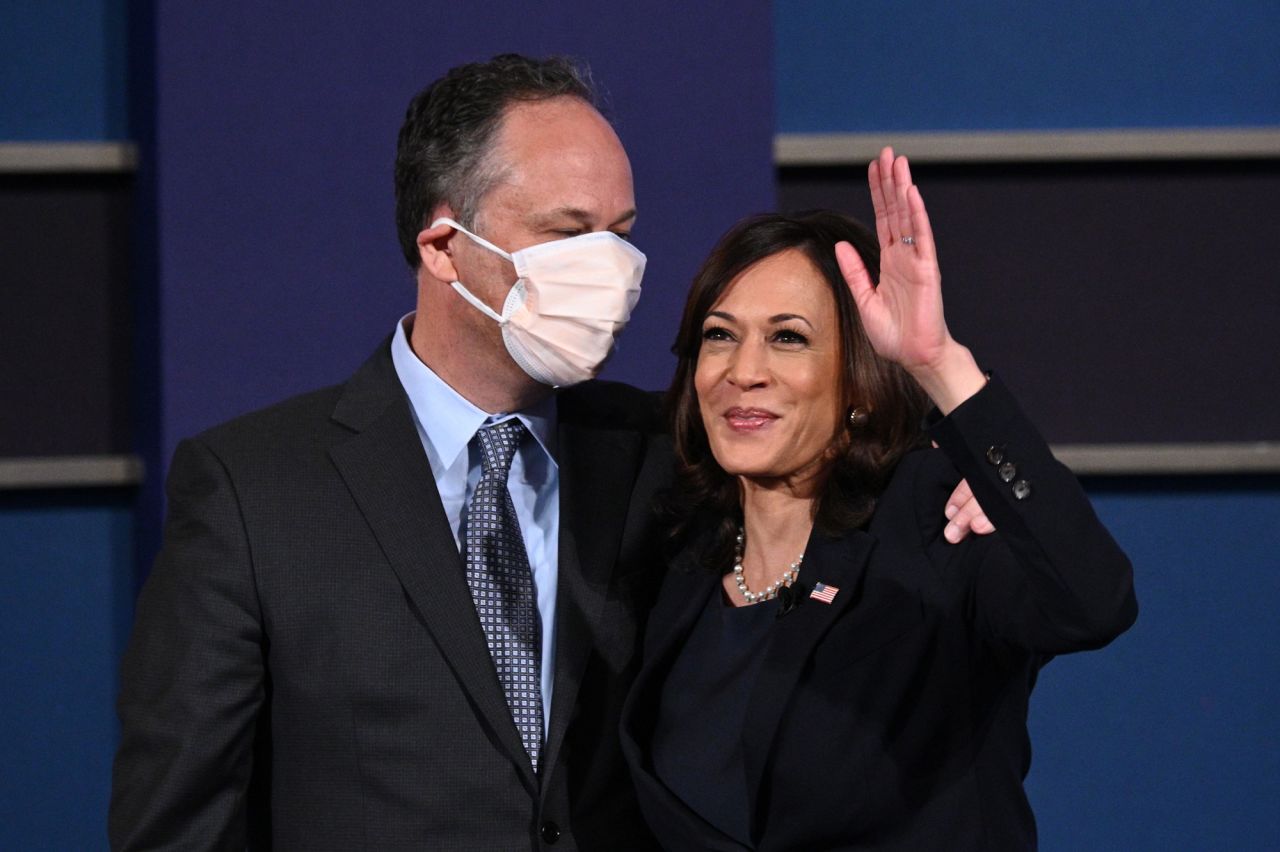 US Democratic vice presidential nominee Kamala Harris and husband Doug Emhoff stand onstage after the vice presidential debate in Kingsbury Hall at the University of Utah on October 7 in Salt Lake City, Utah. 