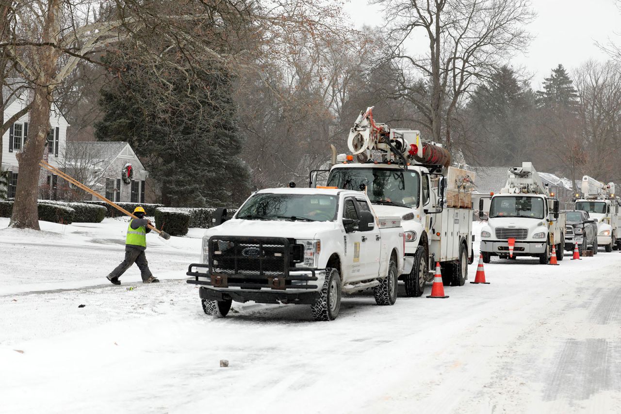 Utility workers restore power to homes in Bloomfield Hills, Michigan, on December 23.