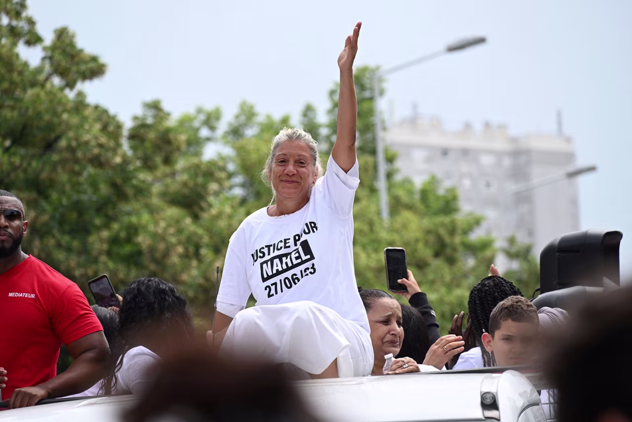 Mounia, identified by CNN affiliate BFMTV, gestures as she sits atop a truck during a march for 17-year-old Nahel in the Paris suburb of Nanterre on June 29. 