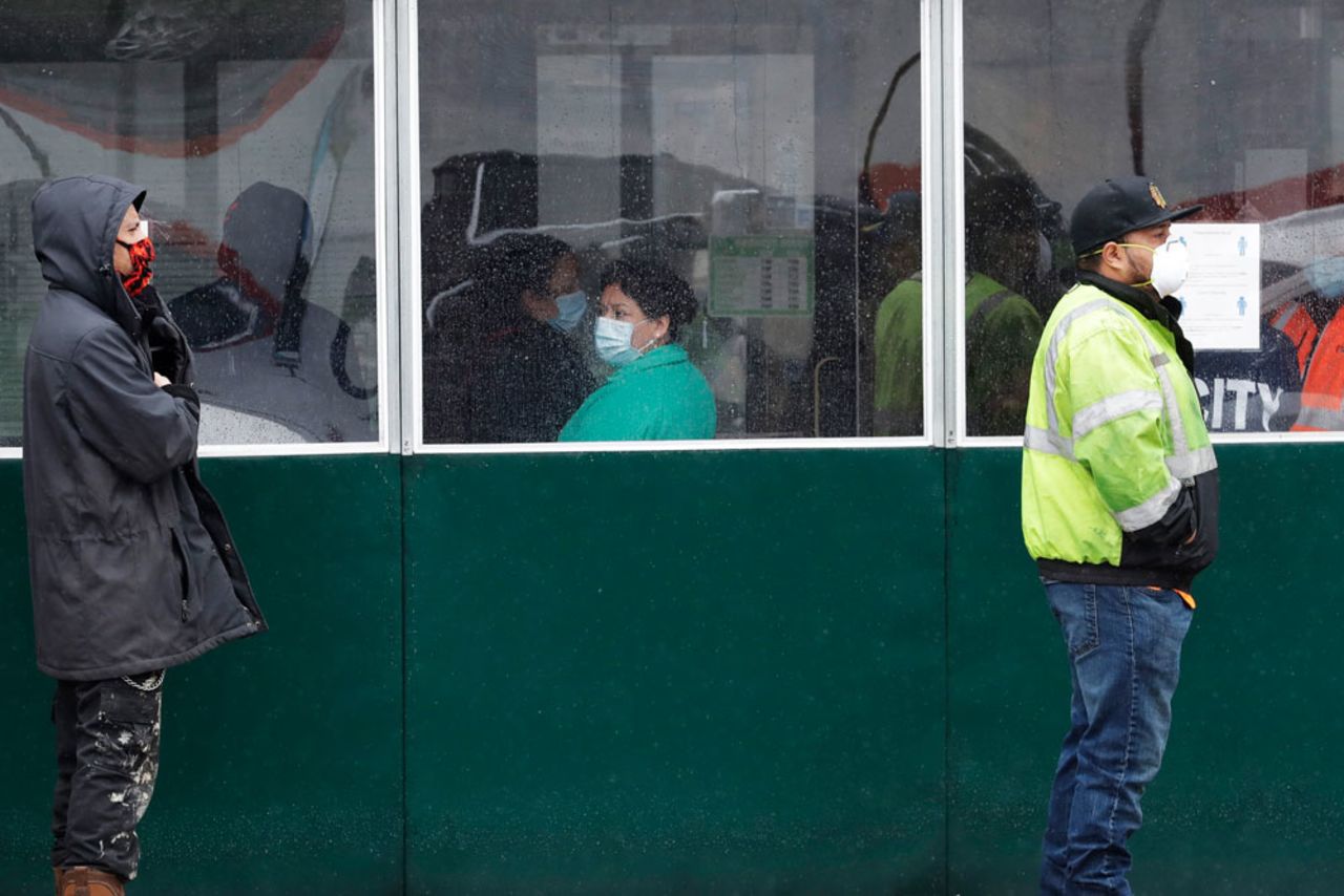 People wait in line outside Tortilleria El Milagro grocery store in Chicago, on Wednesday, April 29.