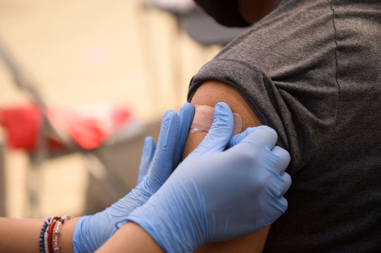 A person receives a bandage after their first dose of the Pfizer Covid-19 vaccine in Los Angeles in August.