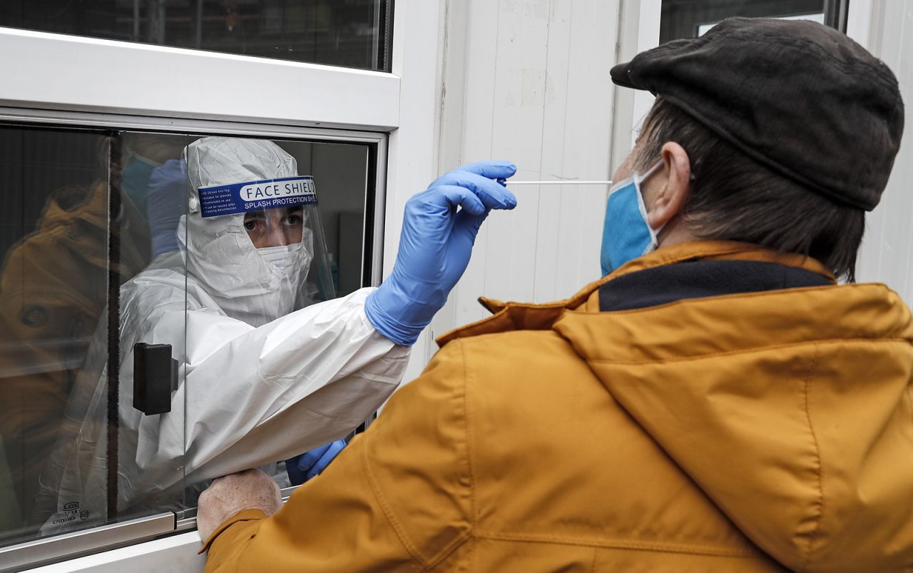 A medical worker takes a nasal swab at a coronavirus testing center in Cologne, Germany, on October 15.