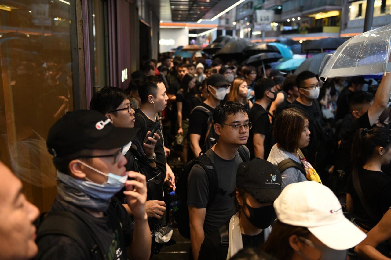 Some protesters shelter in doorways in Hong Kong. 