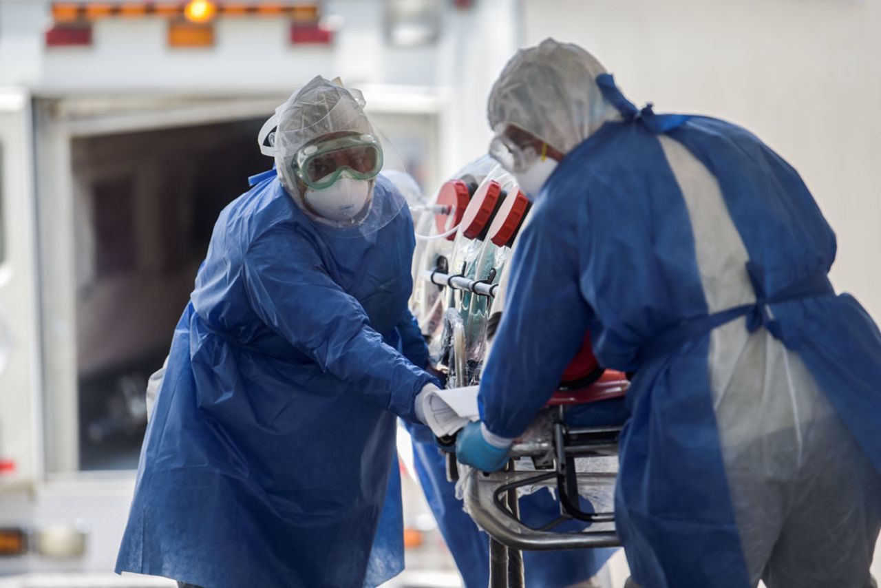 Mexican Red Cross paramedics rush a patient suspected of being infected with the Covid-19 into Venados General Hospital in Mexico City, on May 26.