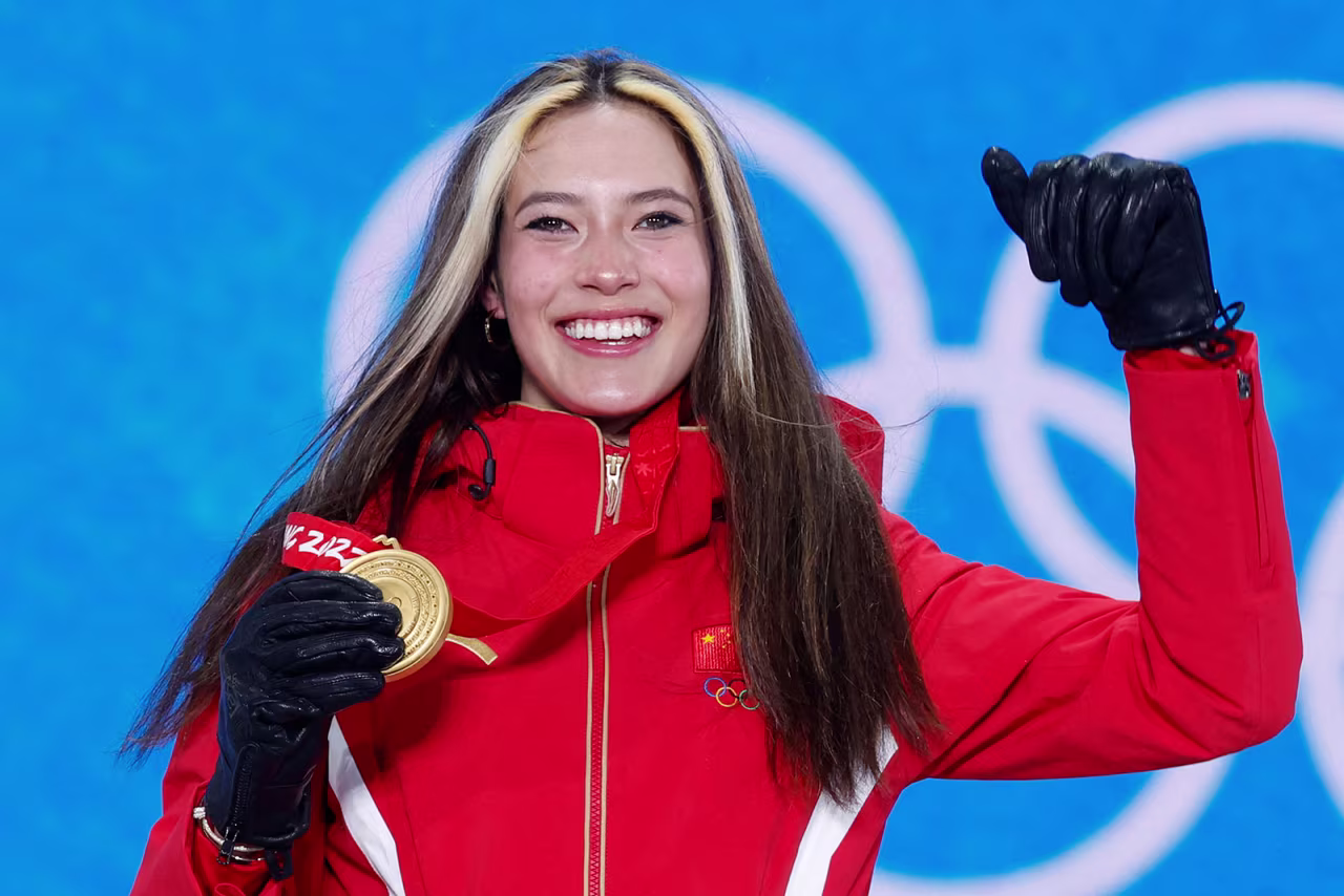 Eileen Gu celebrates during the medal ceremony for the women's freeski halfpipe event on February 18.