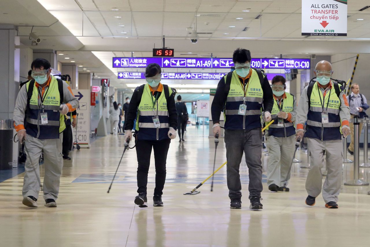 Workers disinfect a passenger throughfare at the Taoyuan International Airport in Taiwan on January 22.