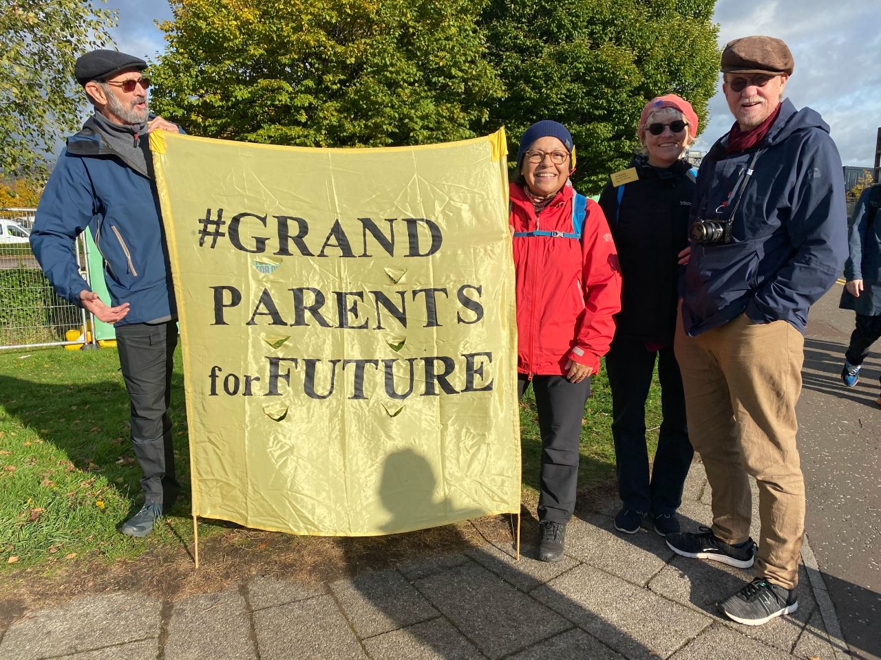 Sten-Ivan Bylund, left, and Amelia Ramirez, right, hold a flag, accompanied by friends.