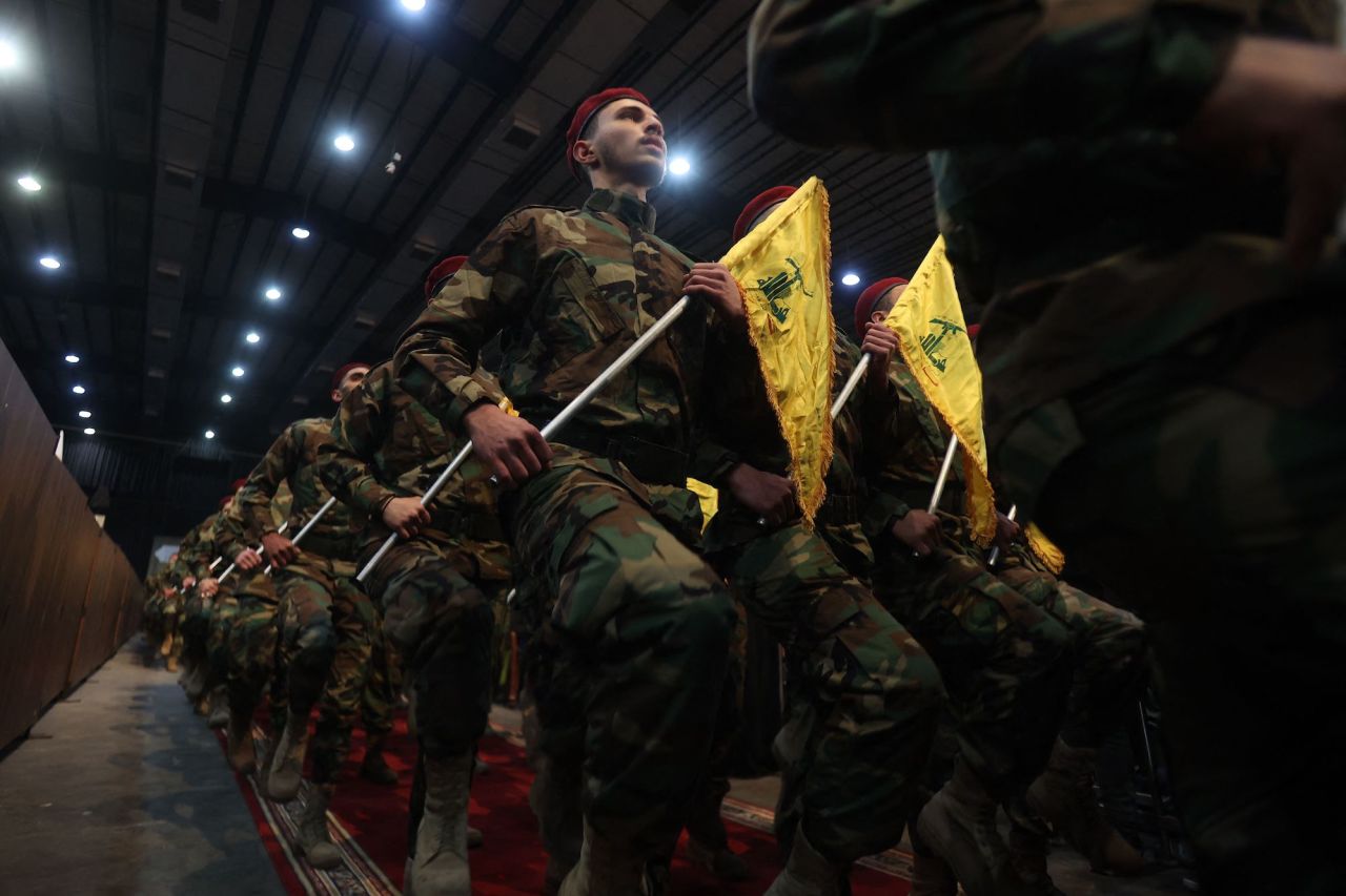 Hezbollah militants parade in Beirut's southern suburbs on April 14.