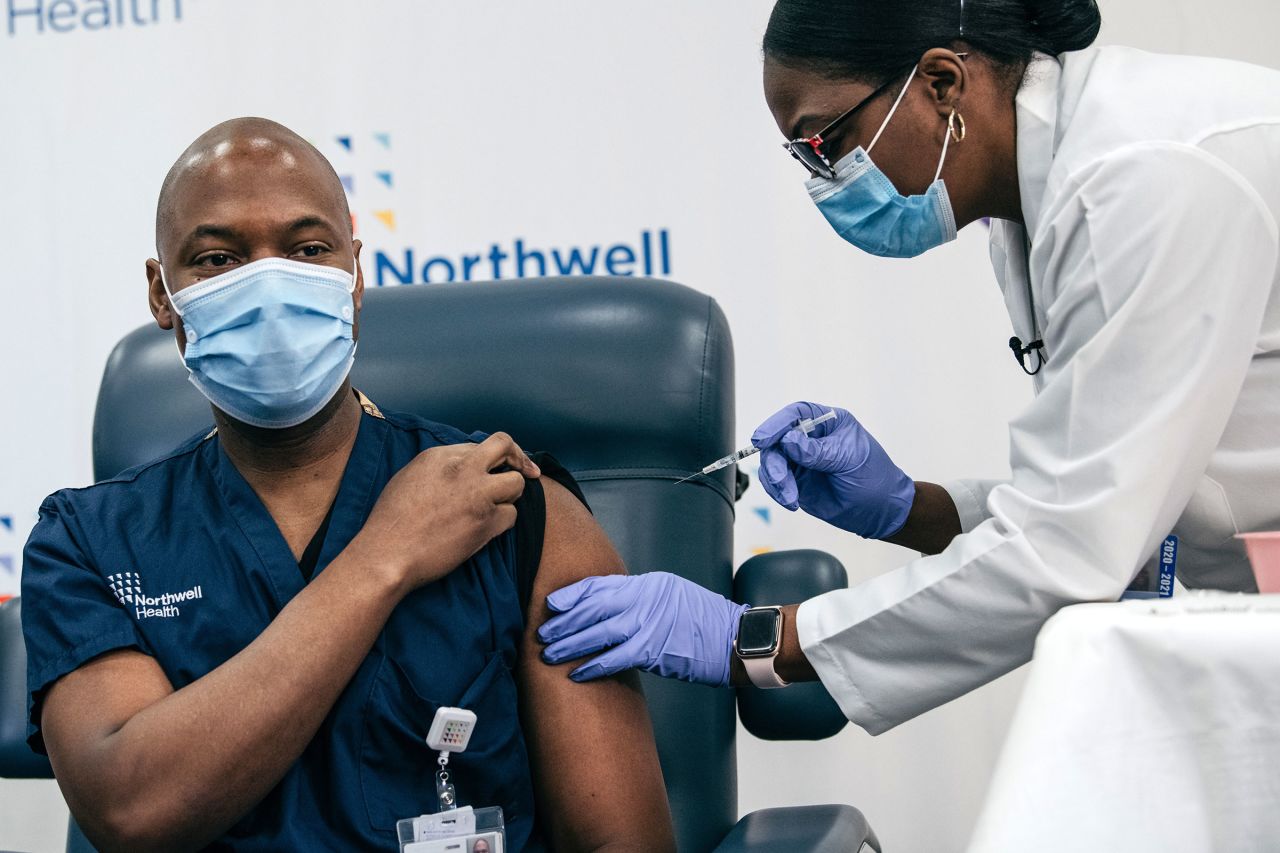 Lenox Hill Hospital Chair of Emergency Medicine Yves Duroseau receives the Covid-19 vaccine from Doctor Michelle Chester at Long Island Jewish Medical Center on December 14 in New York. 