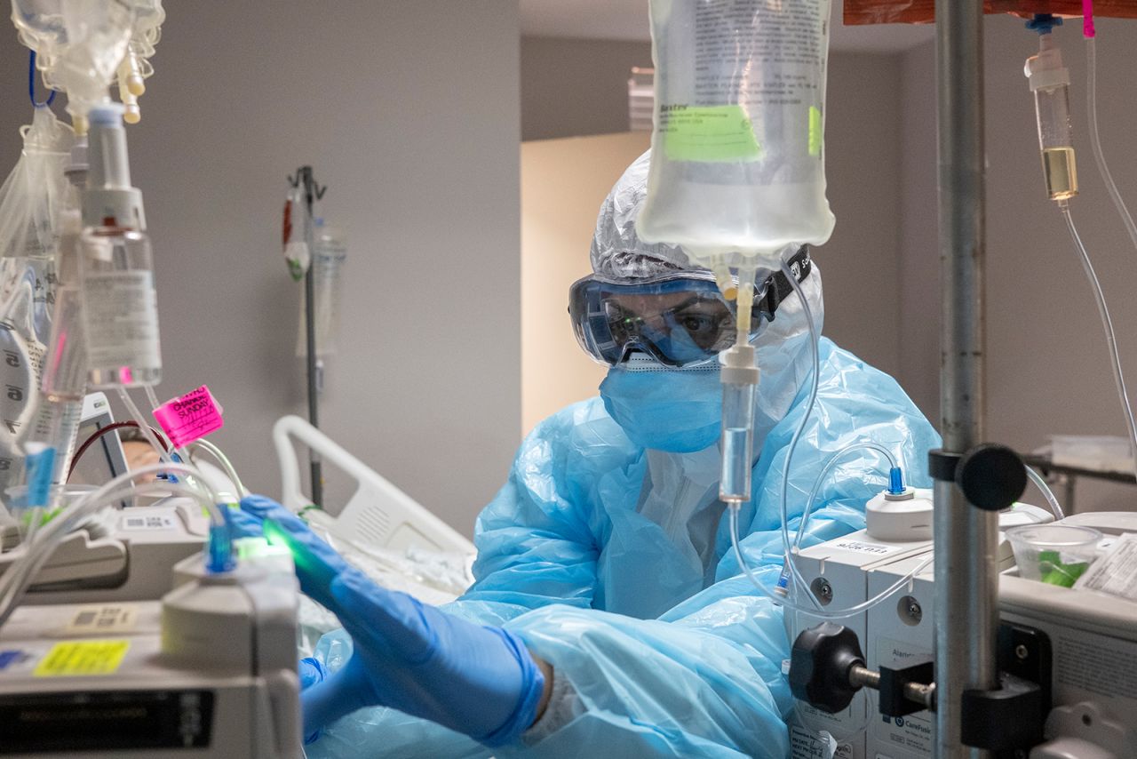 A medical staff member checks an IV pump for a patient in the Covid-19 intensive care unit at the United Memorial Medical Center in Houston, on Dec. 10.