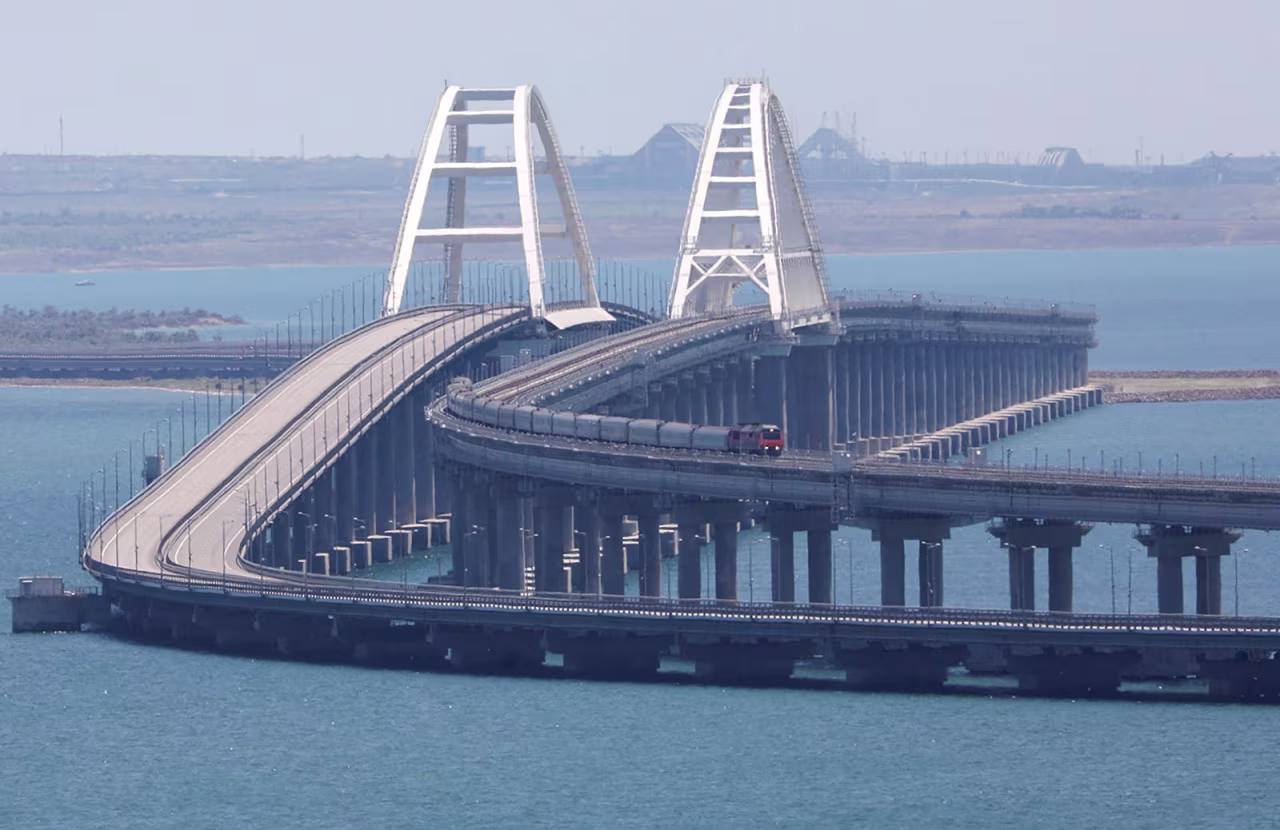 A train moves along the Crimean Bridge as seen from the city of Kerch, Crimea, on Monday, July 17.