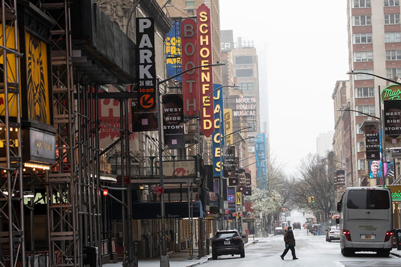 A pedestrian crosses a sparsely populated street in New York's Times Square on Sunday, March 29.