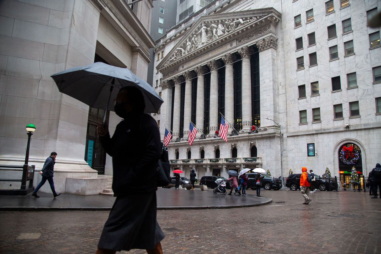 Pedestrians walk past the New York Stock Exchange in New York on January 3. 