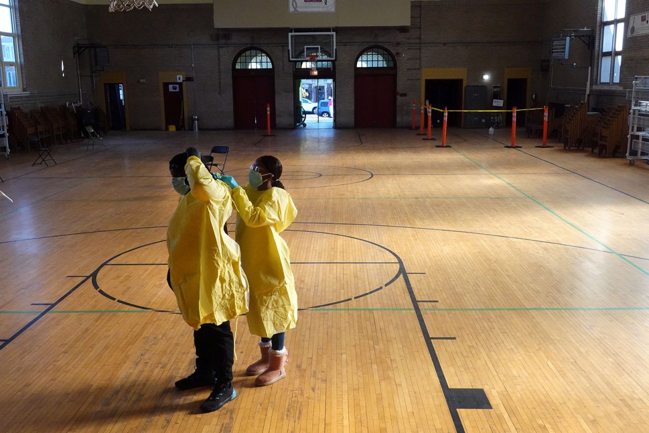 Workers suit up in personal protective equipment as they prepare to open a COVID-19 test site in the Englewood neighborhood of Chicago, on Thursday, November 12.