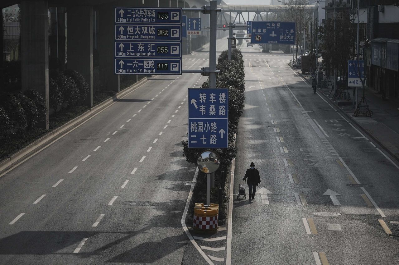 A man drags a handcart across an empty road in Wuhan on February 5.