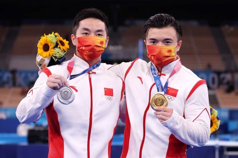 You Hao, left, and Liu Yang of Team China display their medals following the men's rings competition on August 2. 