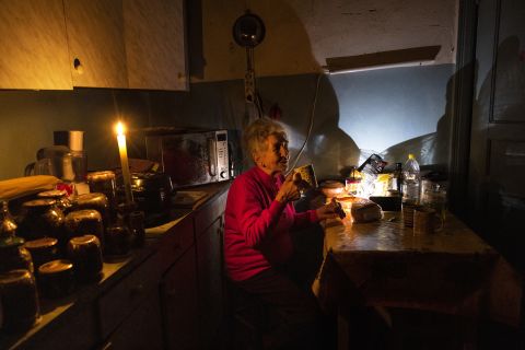Natalia Zemko, 81, drinks tea in her apartment during a power outage in Kyiv, Ukraine on October 22.