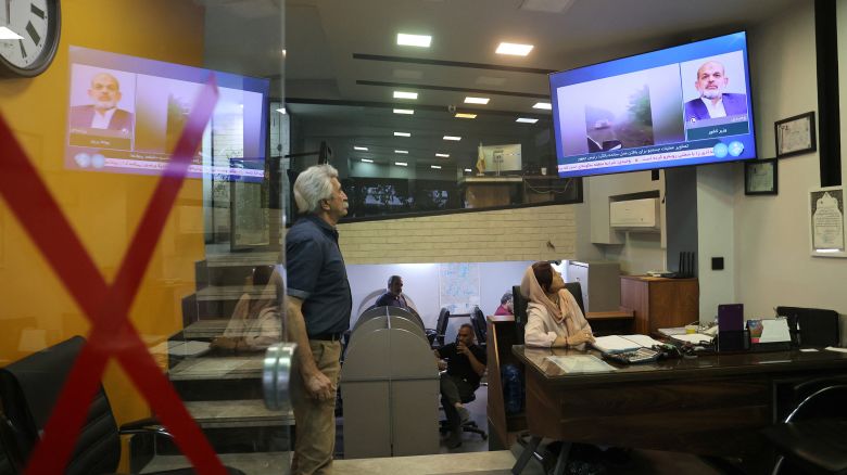 People follow the news about the crash of a helicopter carrying Iran's President Ebrahim Raisi, in a shop in Tehran, Iran, on May 19.