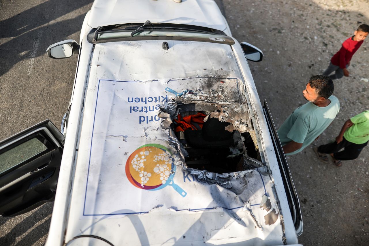 People inspect the damaged vehicle carrying aid workers after Israeli attack in Deir al-Balah, Gaza, on April 2.