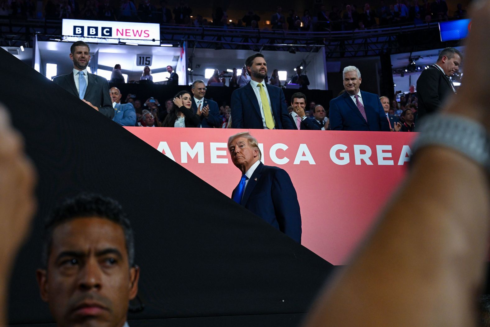 Trump moves toward his seat after arriving at the convention on Tuesday.