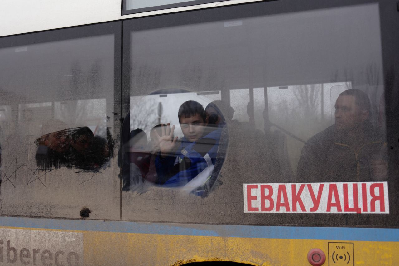 A boy waves as he leaves on an evacuation bus in?Kherson on Thursday.