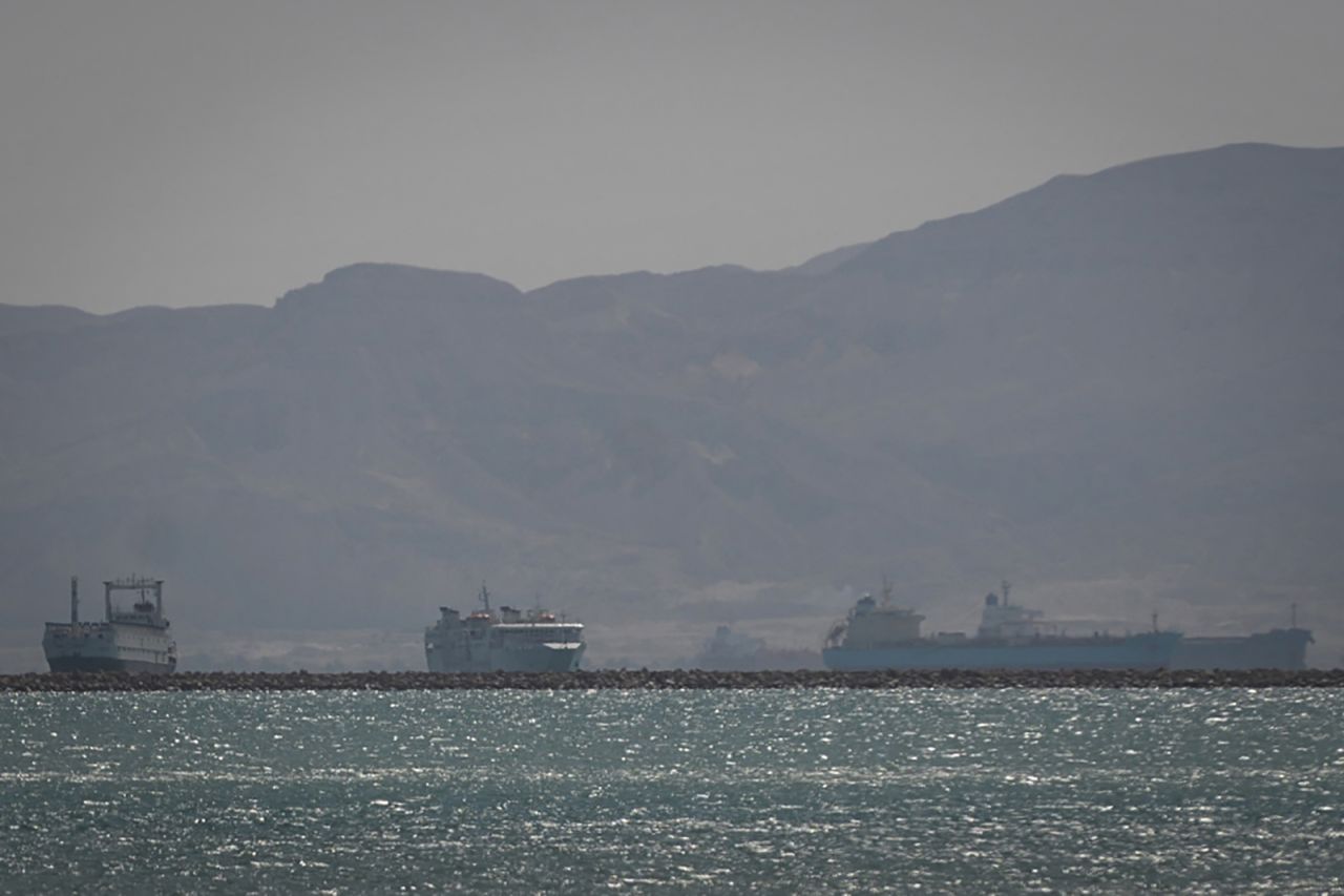 Tugboats and vessels are seen sailing on the Suez Canal, shortly before the "Ever Given" container ship operated by the Evergreen Marine Corporation, was fully freed and floated, on March 29.