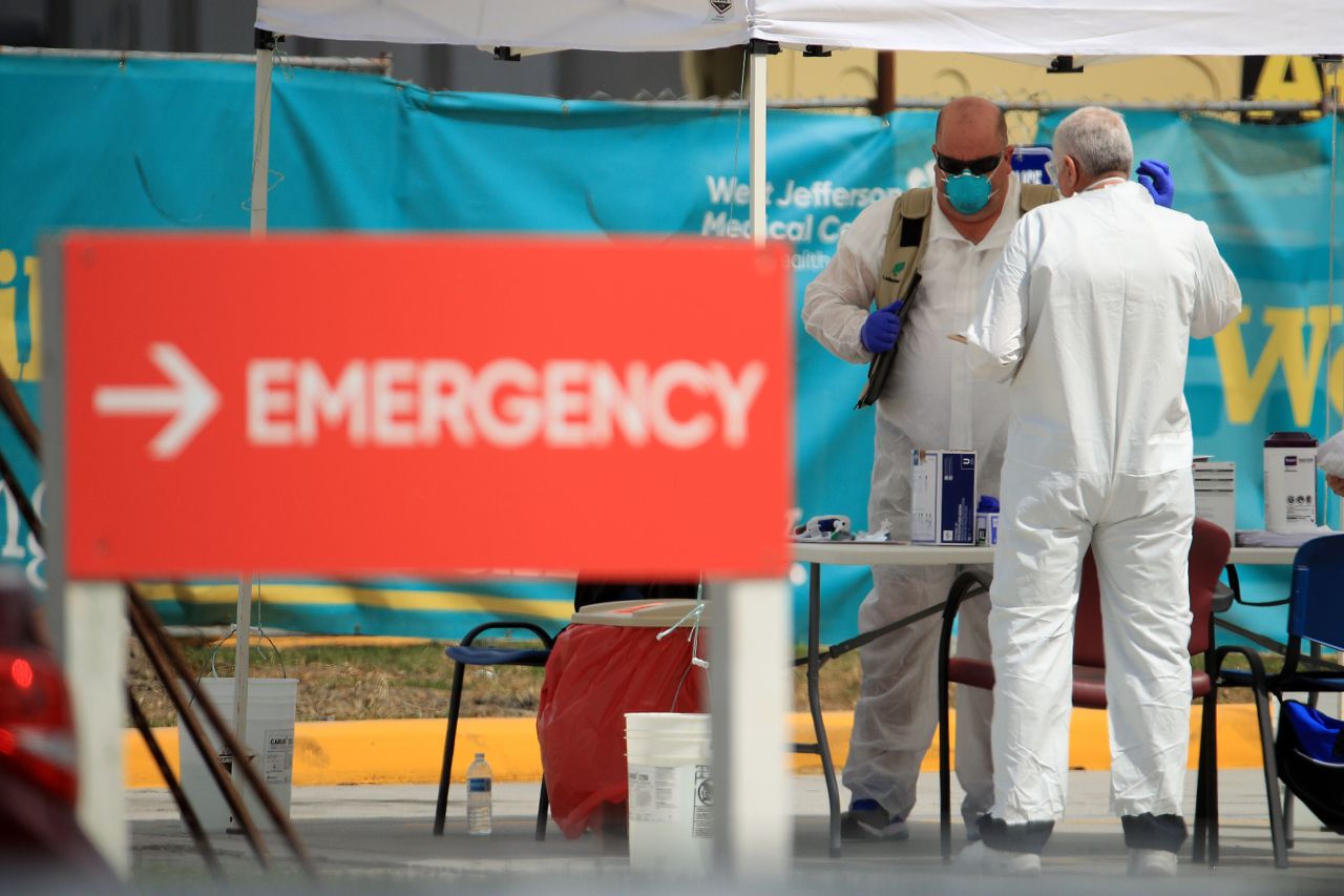 Medical personnel work at a drive-thru coronavirus testing station on March 17 in New Orleans, Louisiana. 