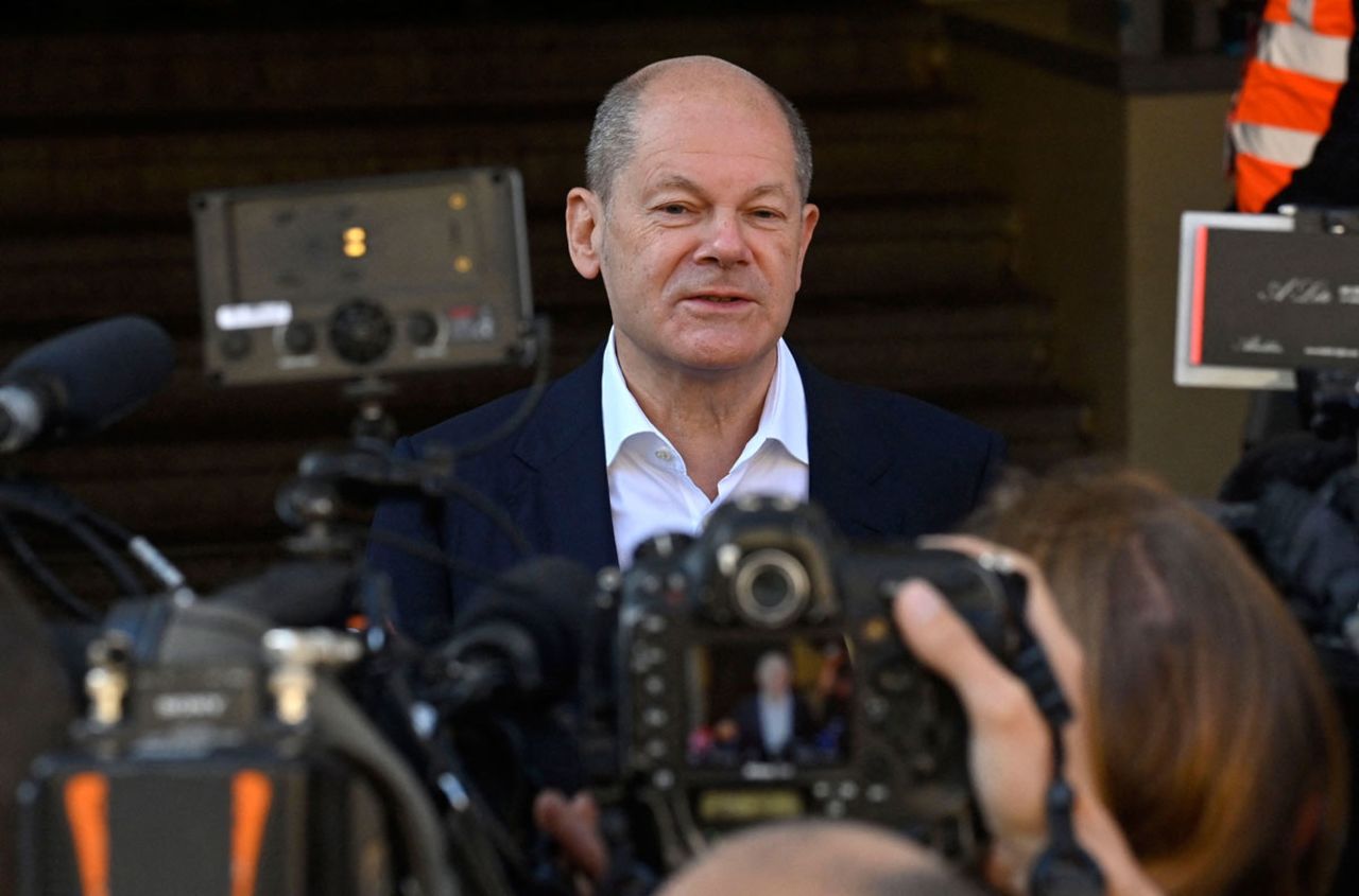 Olaf Scholz speaks to reporters after voting at a polling station in Potsdam, Germany.