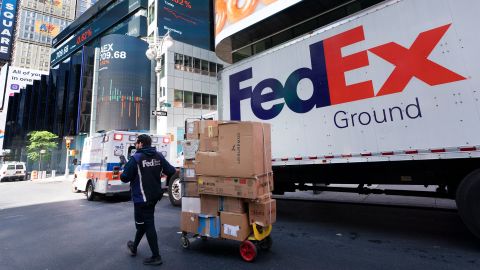 A FedEx driver delivers packages in New York in May.