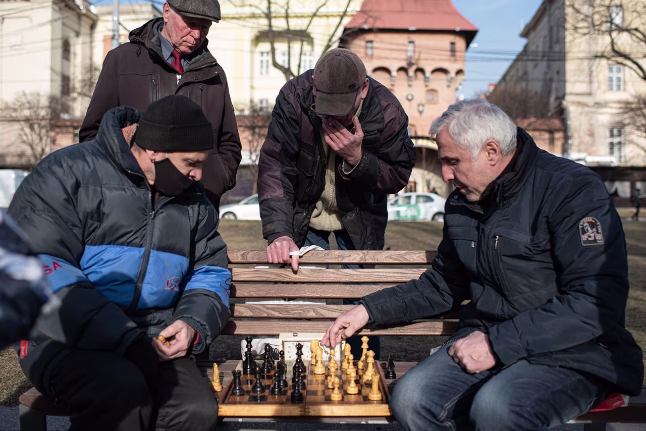 Men play chess on a bench in the boulevard leading to the Lviv Opera House on March 20. 