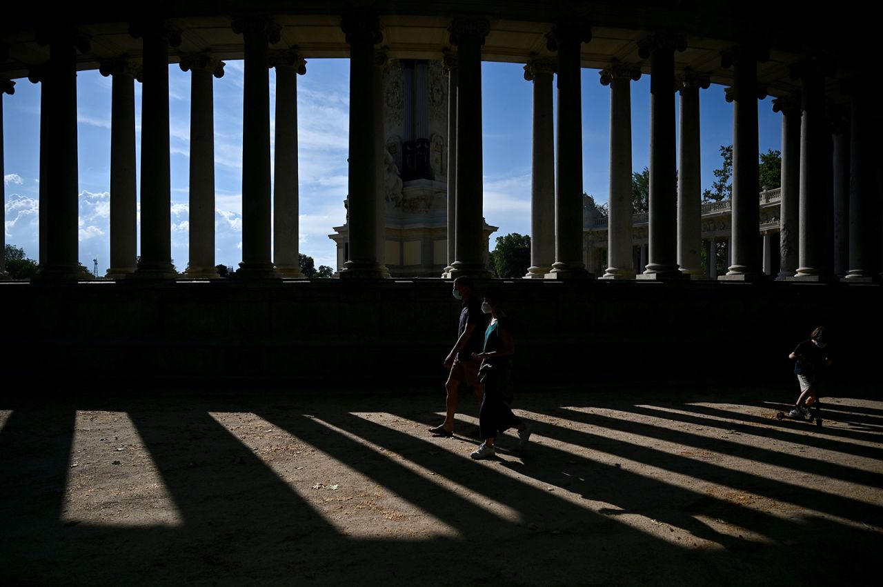 A couple walks at Retiro Park in Madrid on May 26.