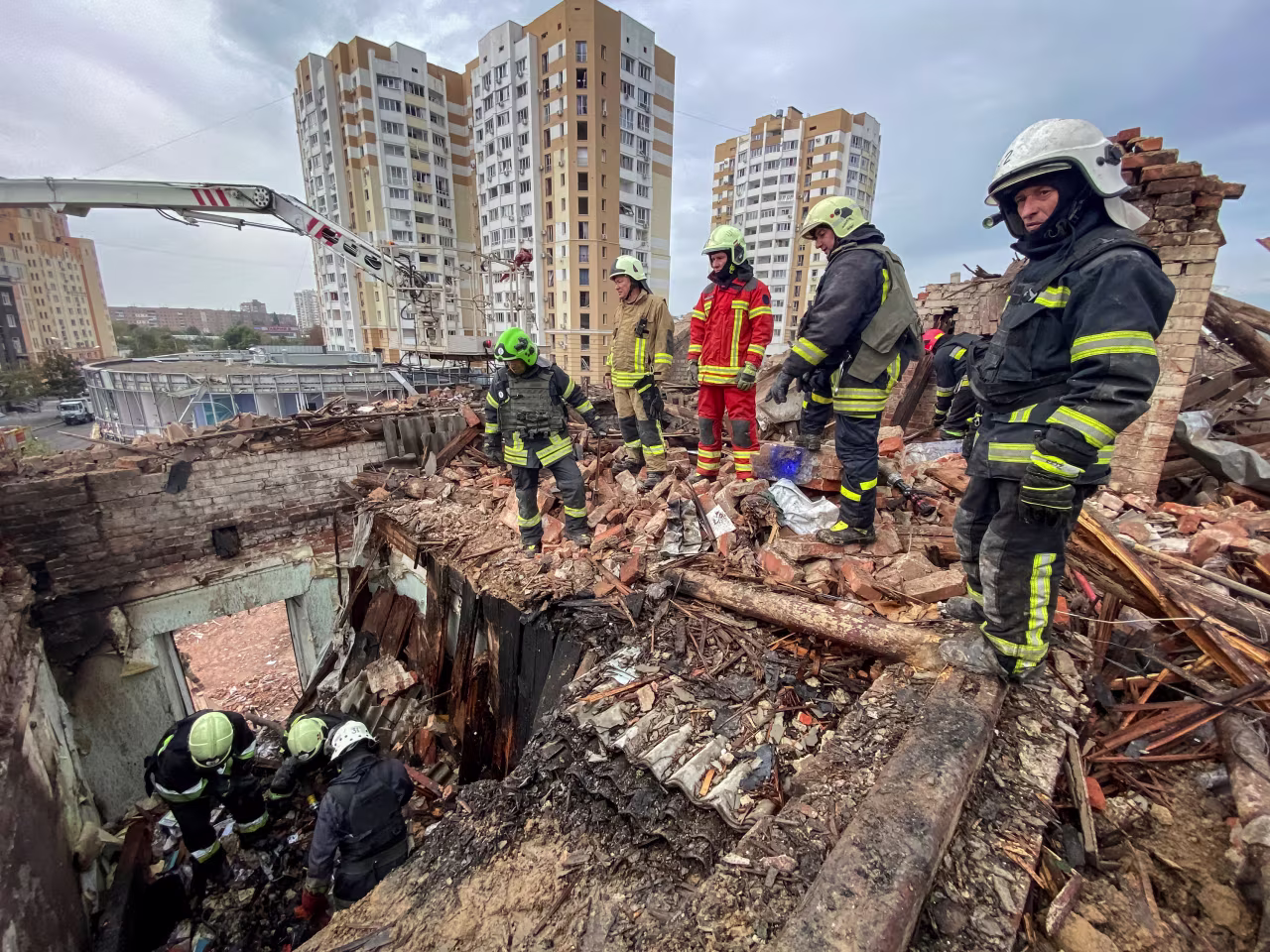 Rescuers work at a site of a residential building damaged by a Russian missile strike in Kharkiv, Ukraine, on October 6, 2023.
