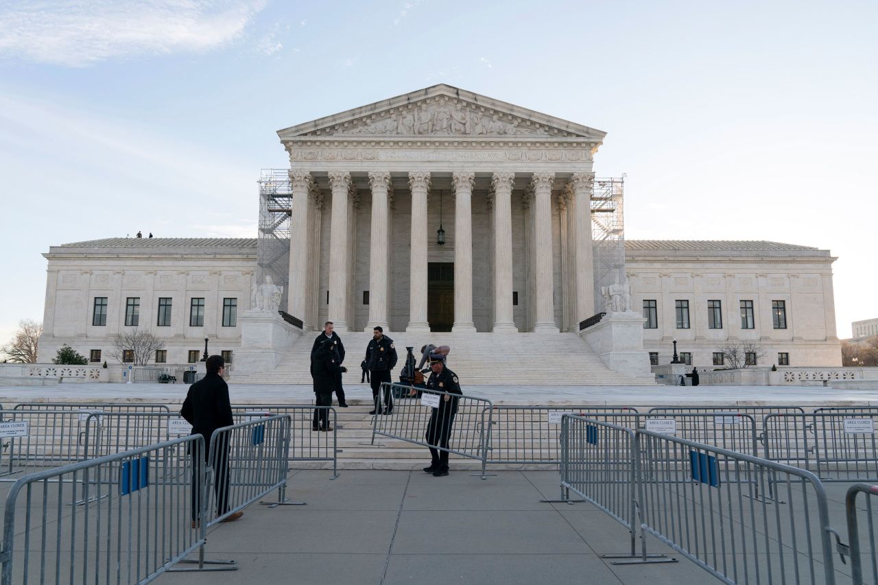 Police set up fencing outside of the Supreme Court on Thursday.