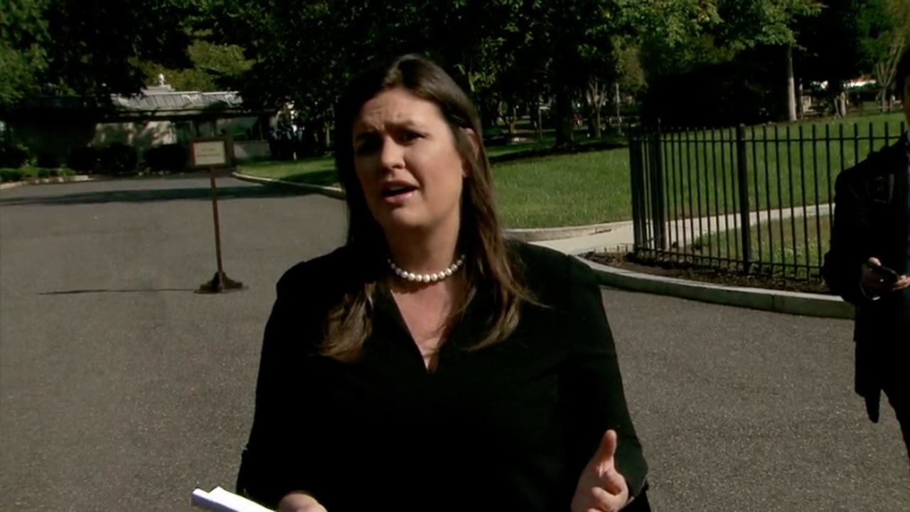 White House press secretary Sarah Sanders speaks to reporters outside the White House.