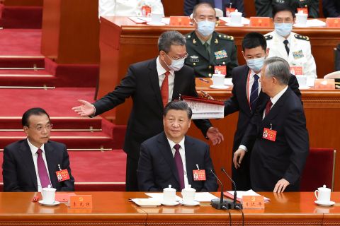 Hu Jintao, left, leaves his seat during the closing ceremony of the 20th National Congress of the Communist Party of China, at the Great Hall of the People in Beijing on October 22.