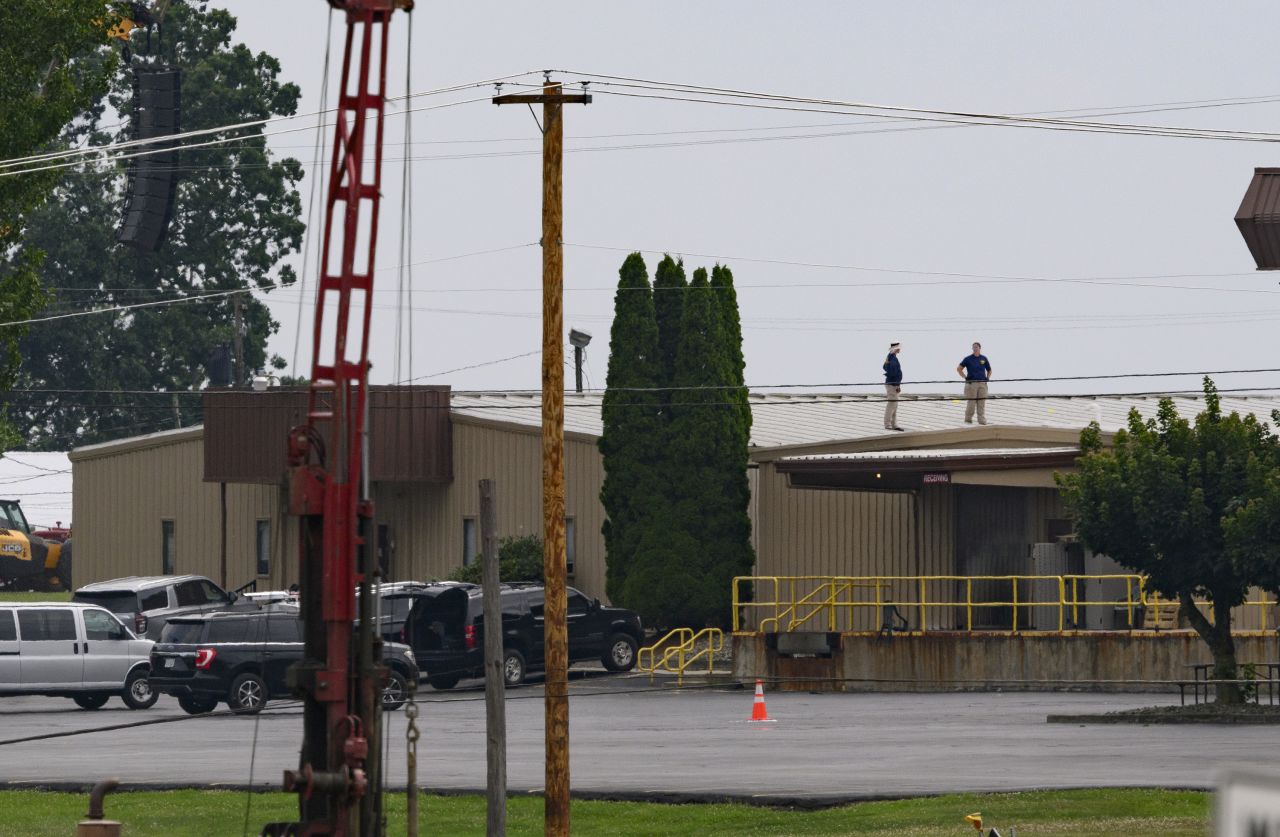 FBI investigators work at the scene of the attempted assassination of former President Donald Trump in Butler, Pennsylvania, the day after shots were fired during a campaign rally.