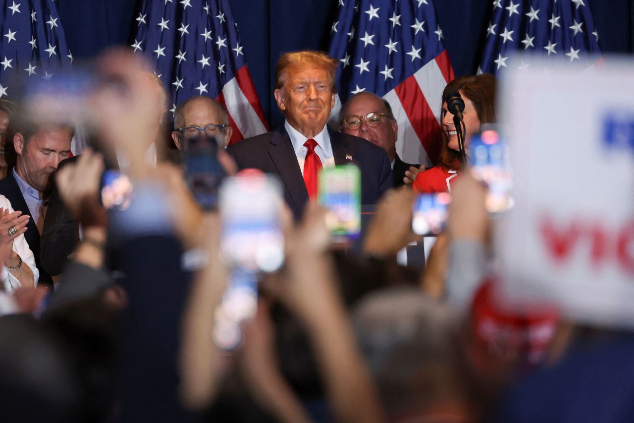 Former President Donald Trump stands on stage as he hosts a South Carolina Republican presidential primary election night party in Columbia, South Carolina, on Saturday.